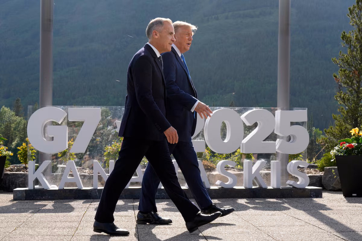 Two men walking at G7 2025 summit.