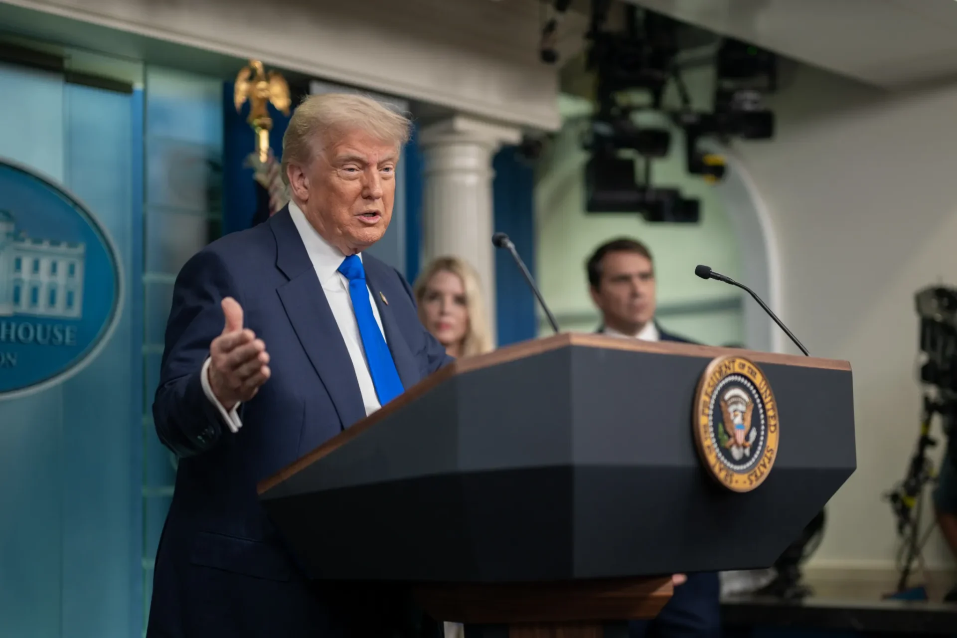 Man speaking at podium with presidential seal
