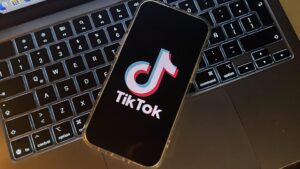 Smartphone displaying TikTok on a laptop.