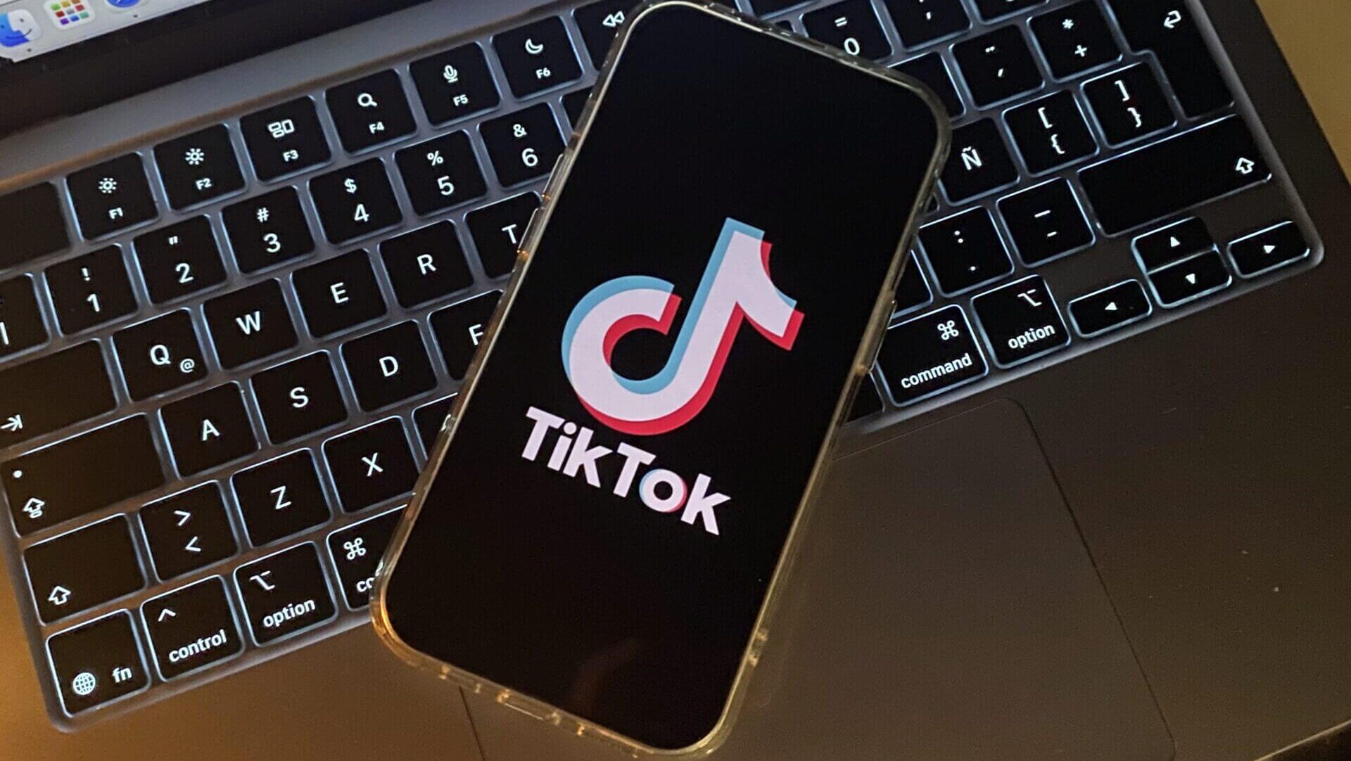 Smartphone displaying TikTok on a laptop.