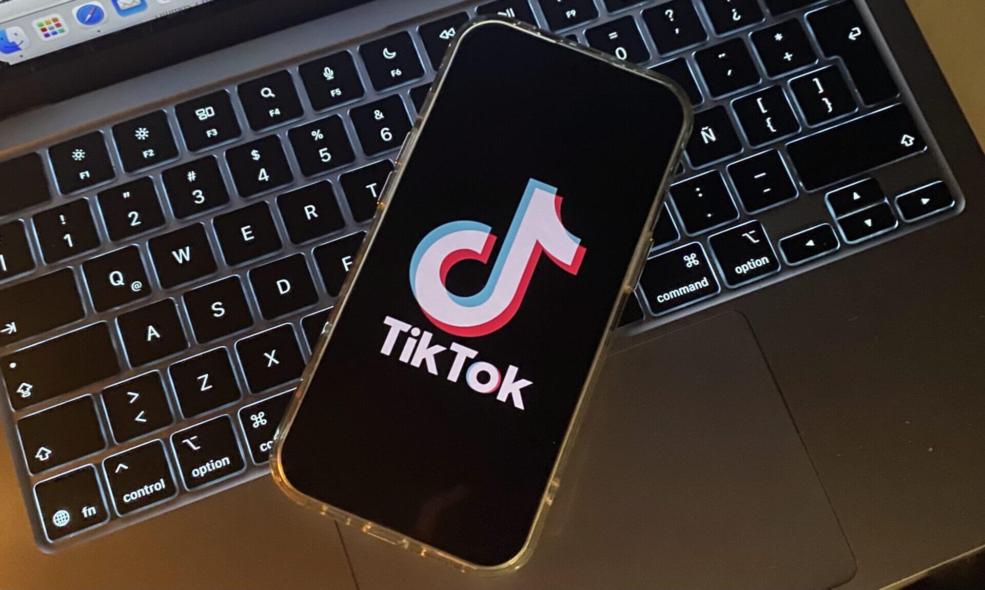 Smartphone displaying TikTok on a laptop.
