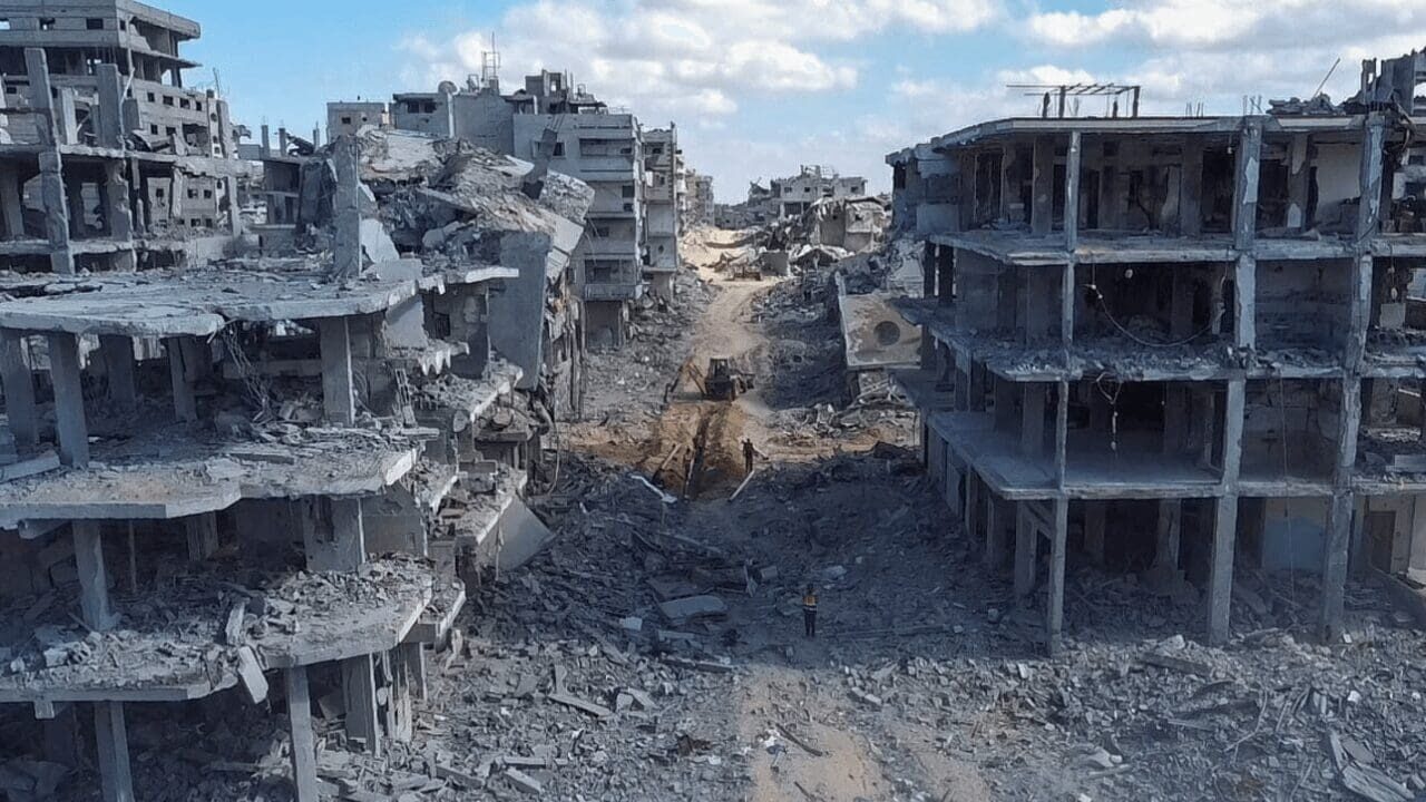 Rubble-filled street between destroyed concrete buildings