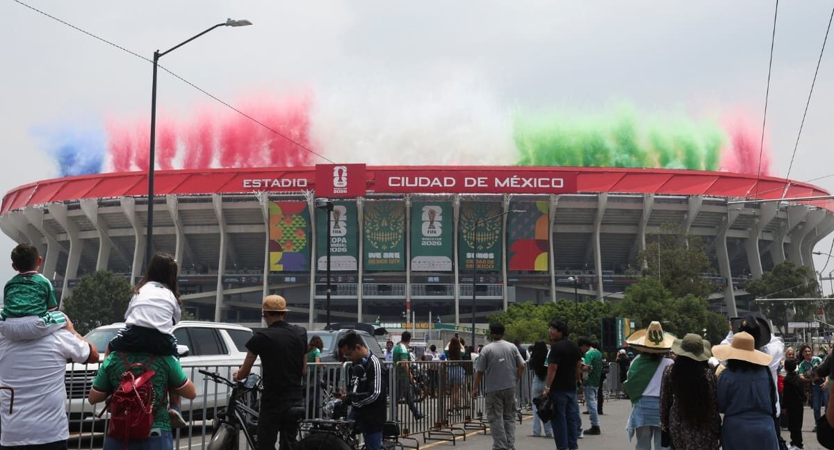 Crowd outside Mexico City stadium with colored smoke