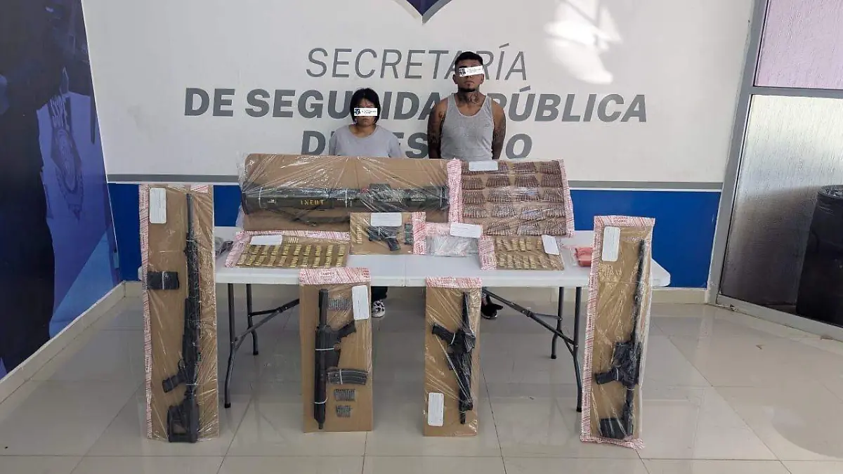 Confiscated weapons and ammunition displayed on table